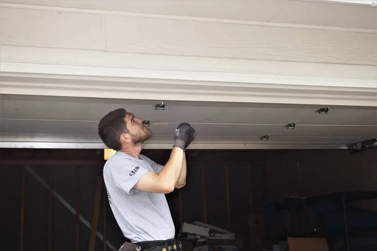 Amega garage door technician fixing a garage door